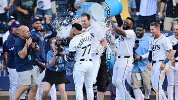 TAMPA, FLORIDA - MARCH 28: Junior Caminero #13 of the Tampa Bay Rays showers Kameron Misner #26 with water after a walk-off home run in the ninth inning to defeat the Colorado Rockies 3-2 in the MLB home opener at George M. Steinbrenner Field on March 28, 2025 in Tampa, Florida. Julio Aguilar/Getty Images/AFP (Photo by Julio Aguilar / GETTY IMAGES NORTH AMERICA / Getty Images via AFP)