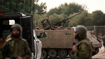 An Israeli soldier sits on the roof of an Armoured Personnel Carrier (APC) near Israel's border with Lebanon, northern Israel, October 9, 2023. REUTERS/Ammar Awad