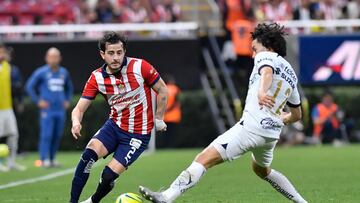 Alan Mozo (R) of Guadalajara fights for the ball with Cesar Huerta (L) of Pumas during the 8th round match between Guadalajara and Pumas UNAM as part of the Torneo Clausura 2024 Liga BBVA MX at Akron Stadium on February 24, 2024 in Guadalajara Jalisco, Mexico.